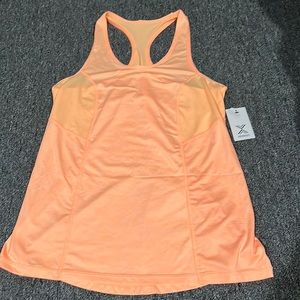I am selling a brand new with tag Xersion brand tank top in Arctic Orange.